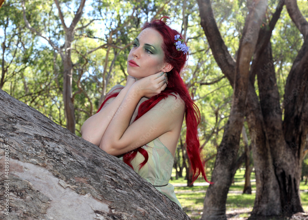 fantasy portrait of fairy girl with flowers in red hair and a pretty green dress, posing in enchanted forrest background. fantasy portrait of fairy girl with flowers in red hair and a pretty green dress, posing in enchanted forrest background.