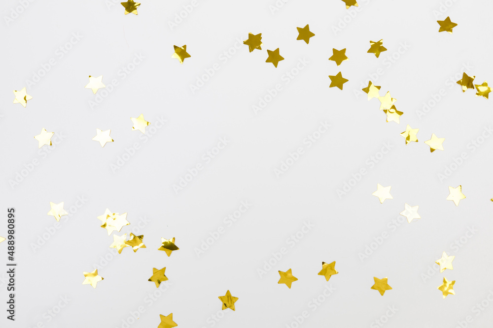 golden confetti on white background flat lay text place . golden confetti on white background flat lay text place .