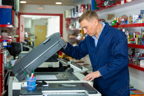 Service engineer using a copy machine. High quality photo