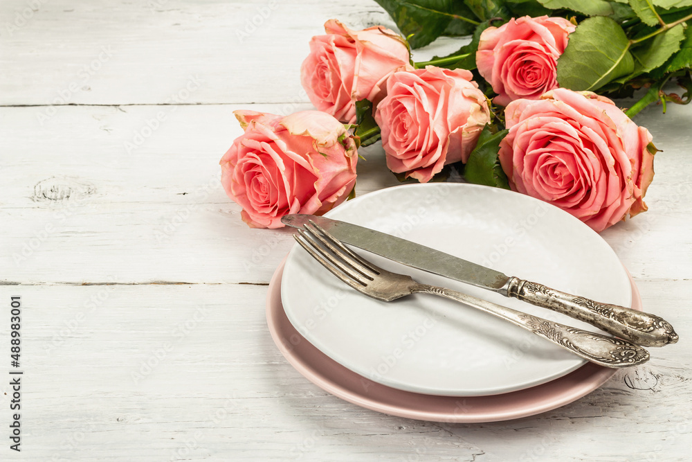 Romantic dinner table on white wooden background. Love concept for Valentine's or Mother's day Romantic dinner table on white wooden background. Love concept for Valentine's or Mother's day