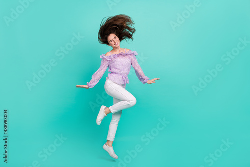 Fototapeta Naklejka Na Ścianę i Meble -  Full size photo of pretty adorable girl flying hair good mood free time isolated on turquoise color background