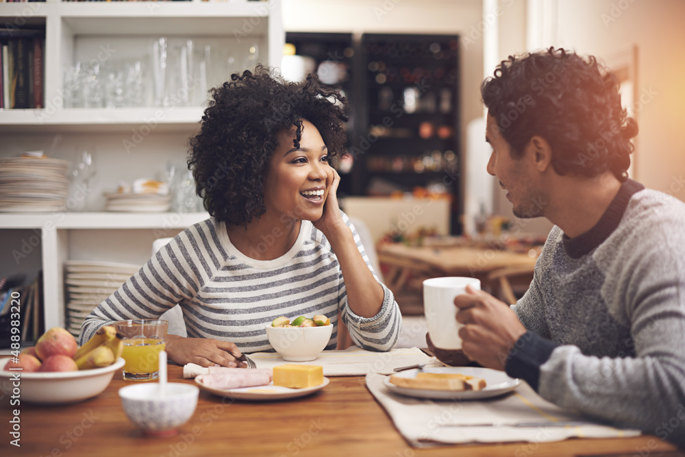 Enjoying a leisurely breakfast together. Shot of a couple eating breakfast together at home. Enjoying a leisurely breakfast together. Shot of a couple eating breakfast together at home.