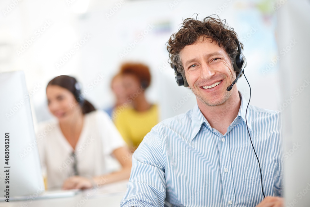 Fototapeta premium Were the call center you need. Cropped portrait of a handsome call center operator in the office.
