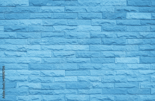 Brick wall painted with blue dark paint pastel calm tone texture background.