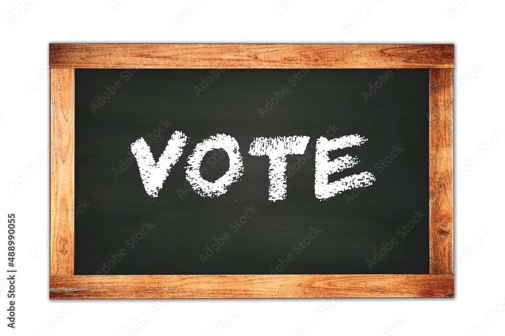 VOTE text written on wooden frame school blackboard. VOTE text written on wooden frame school blackboard.