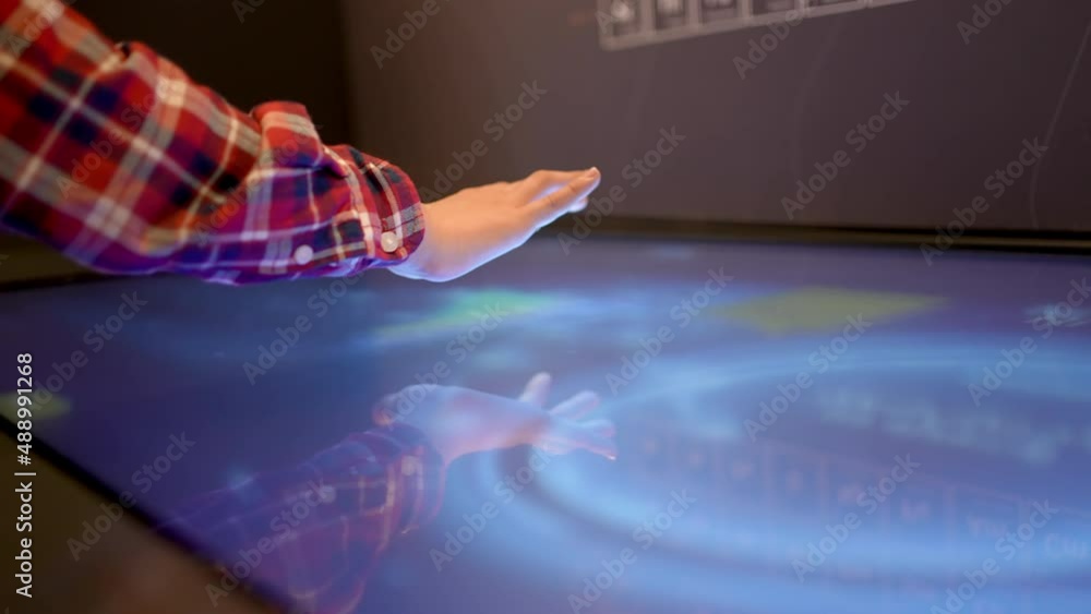 Finger hand of boy child turns monitor virtual touch screen button with ...