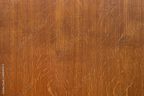 Old brown rustic cut wooden board texture with tiny scratches on surface as background. Blank wooden board pattern design macro
