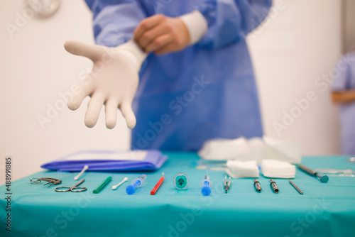 Doctor preparing for a surgery with his instruments in front of him photo