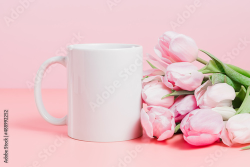 Closeup of mockup mug with pink tulips, spring concept