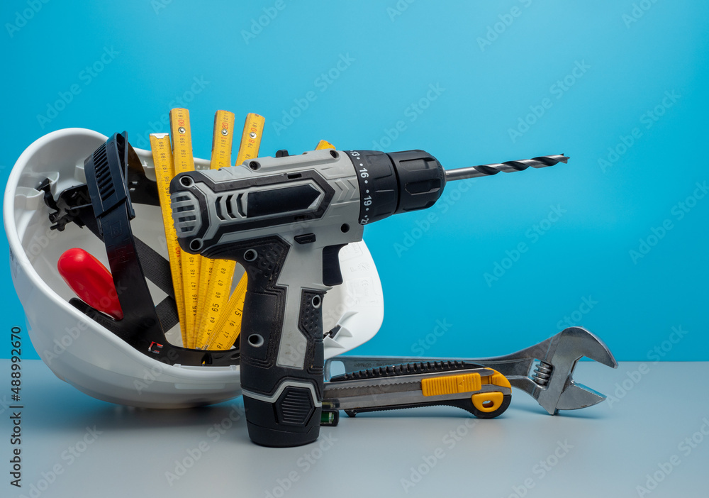 Fototapeta premium White construction helmet and construction tools.