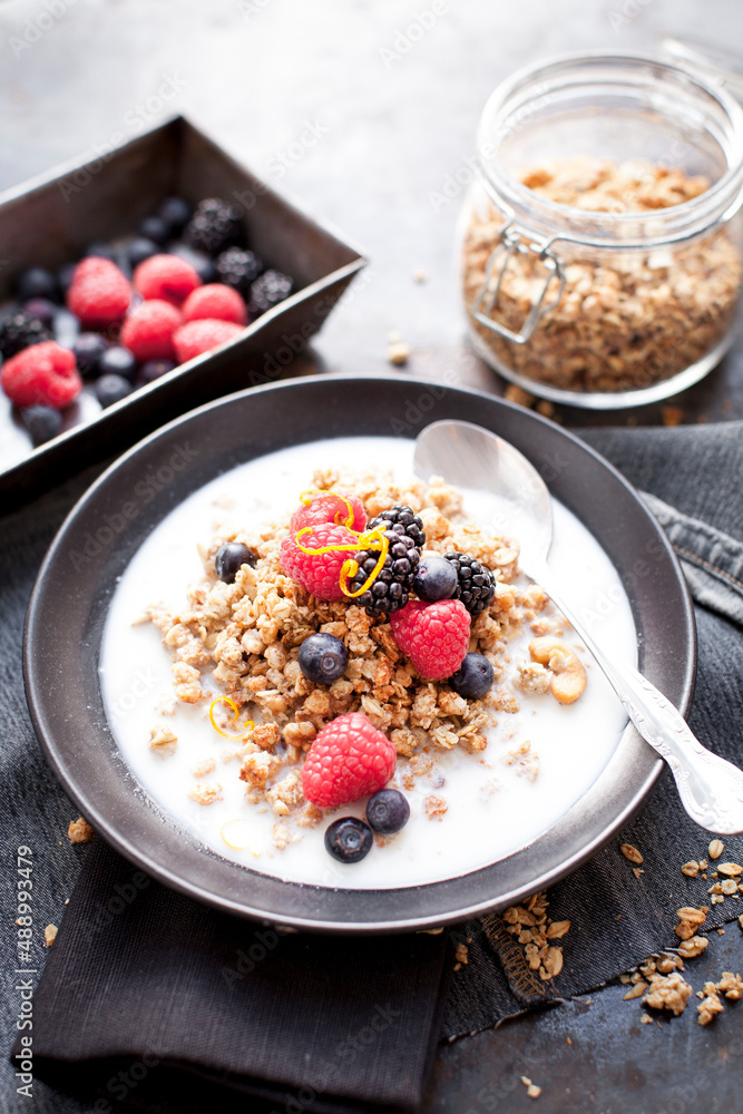 Healthy breakfast with muesli, rice milk and berries on dark background Healthy breakfast with muesli, rice milk and berries on dark background
