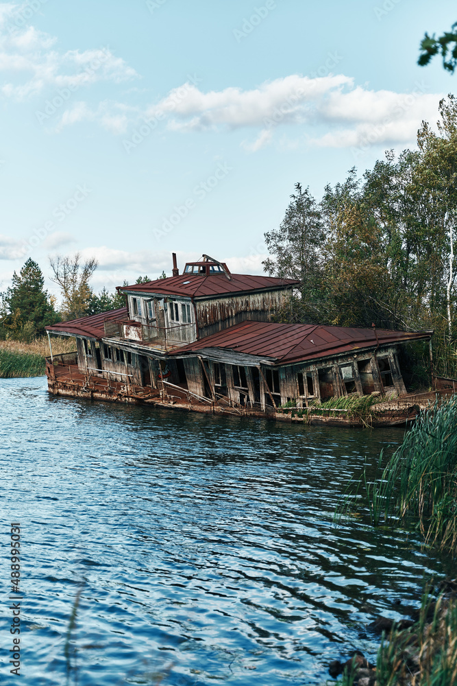 Abandoned floating boat restaurant in the harbour of ghost town Pripyat, Chernobyl, Ukraine. Ship Abandoned floating boat restaurant in the harbour of ghost town Pripyat, Chernobyl, Ukraine. Ship