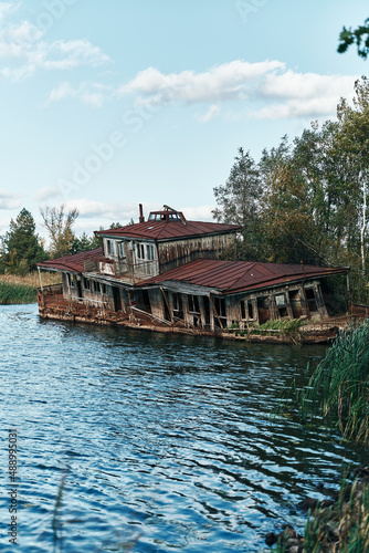 Abandoned floating boat restaurant in the harbour of ghost town Pripyat, Chernobyl, Ukraine. Ship © visualitte