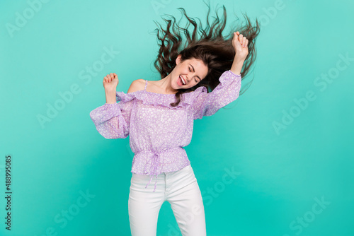 Fototapeta Naklejka Na Ścianę i Meble -  Portrait of attractive dreamy crazy cheerful wavy-haired girl dancing hit isolated over bright blue color background
