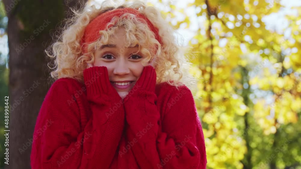Surprised young woman with red sweater into a woods, slow motion. Autumn Park Location. Medium Close up Surprised young woman with red sweater into a woods, slow motion. Autumn Park Location. Medium Close up