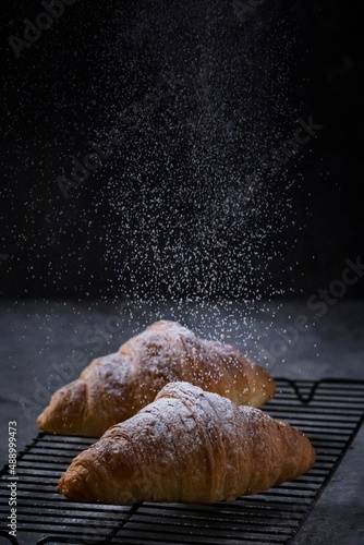 Croissant with powdered sugar photo