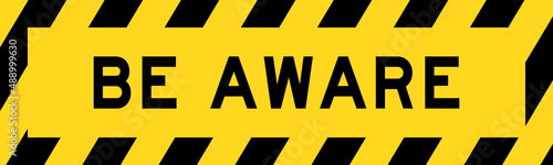Yellow and black color with line striped label banner with word be aware photo