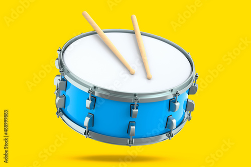 Realistic drum and wooden drum sticks on yellow. 3d render of musical instrument