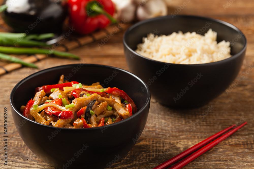Pork chop with peppers, mushrooms and bamboo. Served with rice. Pork chop with peppers, mushrooms and bamboo. Served with rice.