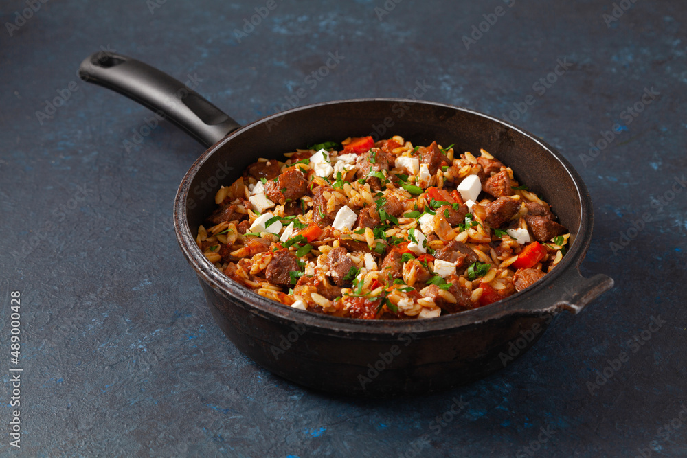 Traditional Greek cuisine. Lamb stew with feta cheese and vegetables. Traditional Greek cuisine. Lamb stew with feta cheese and vegetables.