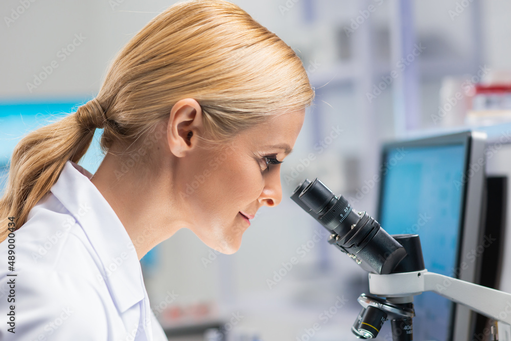 Professional female scientist is working on a vaccine in a modern scientific research laboratory. Genetic engineer workplace. Future technology and science. Professional female scientist is working on a vaccine in a modern scientific research laboratory. Genetic engineer workplace. Future technology and science.