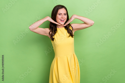 Portrait of attractive cheerful gorgeous elegant wavy-haired girl posing having fun isolated over bright green color background