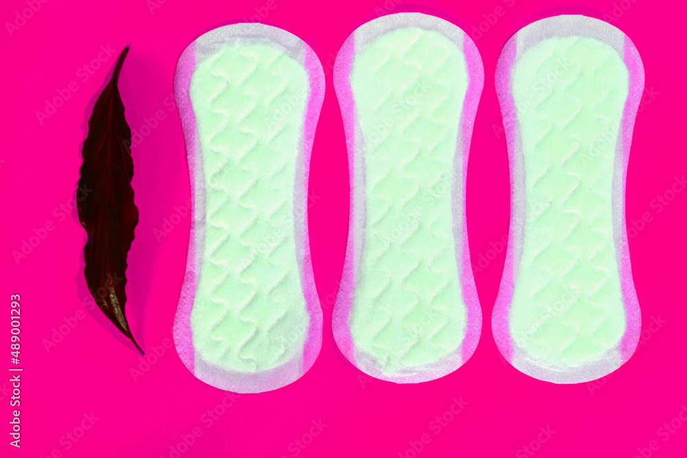 women's pads with leaves on a pink background women's pads with leaves on a pink background
