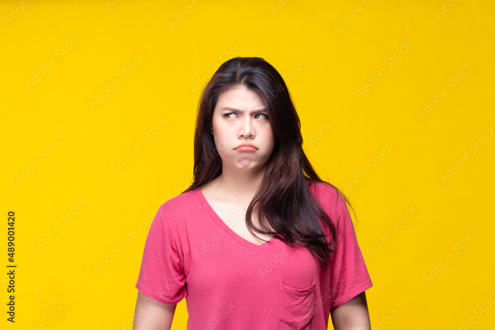 Image of feeling excited, shock, surprise and happy. Young asian woman standing on yellow background. Female face expressions and emotions body language concept. Image of feeling excited, shock, surprise and happy. Young asian woman standing on yellow background. Female face expressions and emotions body language concept.
