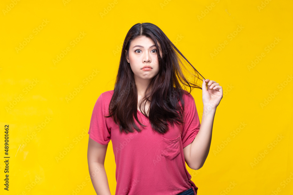 Fototapeta premium Image of feeling excited, shock, surprise and happy. Young asian woman standing on yellow background. Female face expressions and emotions body language concept.