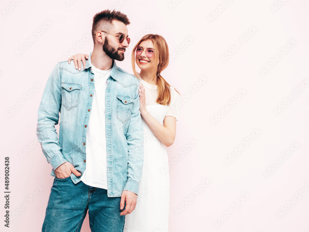Sexy smiling beautiful woman and her handsome boyfriend. Happy cheerful family having tender moments near pink wall in studio.Pure cheerful models hugging.Embracing each other. Cheerful and happy