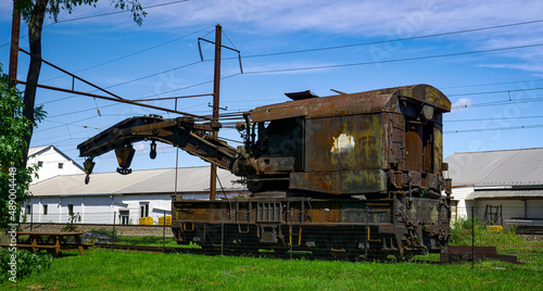 Slika na platnu View of a Rusting of Train Steam Crane sitting on a Track Rusting Away on a Sunn