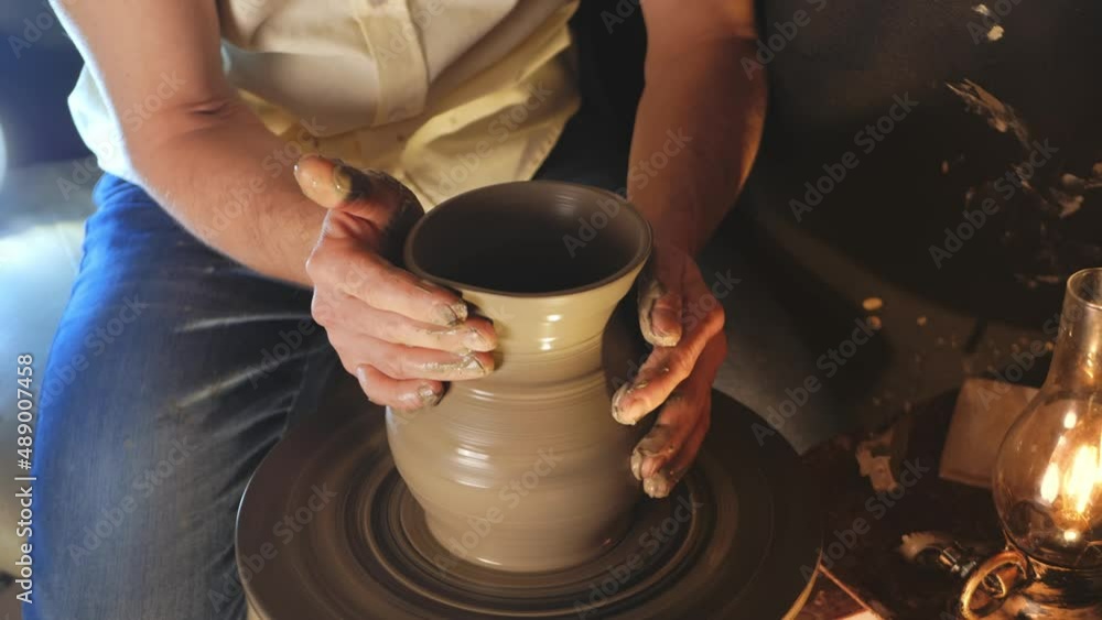 man makes jug in pottery workshop, clay product, authentic atmosphere, background, footage. Lifestyle, indoor, cinema. Macro, close-up, hands. Magic light man makes jug in pottery workshop, clay product, authentic atmosphere, background, footage. Lifestyle, indoor, cinema. Macro, close-up, hands. Magic light