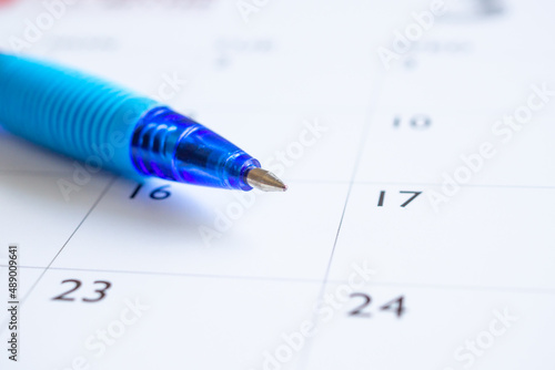 Blue pen on calendar page background business planning appointment meeting concept