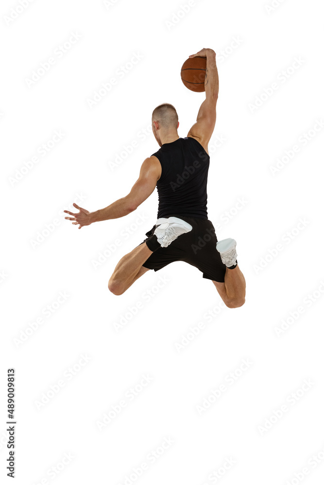 Back view. Portrait of basketball player jumping with ball isolated on white studio background. Sport, motion, activity concepts. Dunk, jam, stuff technic