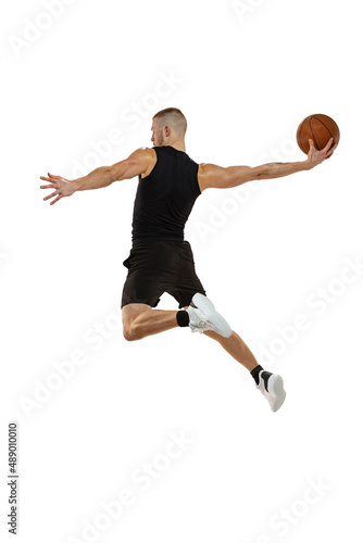 Dynamic portrait of basketball player jumping with ball isolated on white studio background. Sport, motion, activity concepts. Dunk, jam, stuff technic © master1305