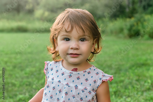 Cute Toddler Girl outdoors with a strawberry hemangioma nevus birthmark on her neck
