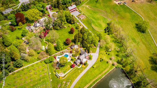 Obraz na plátně Aerial View of Countryside of Homes With a Pond and Fountain Viewed by a Gazebo