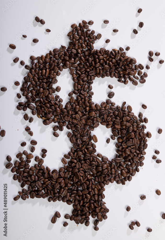 symbolic picture of coffee beans forming a dollar sign as symbol for increasing coffee prices symbolic picture of coffee beans forming a dollar sign as symbol for increasing coffee prices