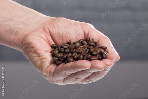 close up of a hand full of roasted coffee beans