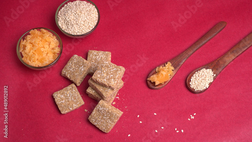 Indian makar sankranti festival food or sweets. Tilgul in a small bowl. Tilgul is made out of sesame seeds, peanuts, and jaggery. Til gud chikki or sesame candy. Copy Space.