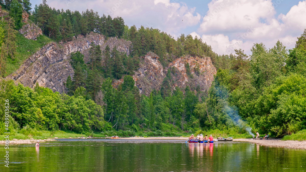 Rafting on the Ural River along steep cliffs.