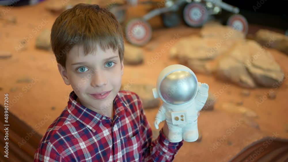 Happy cute boy dreaming flying toy astronaut rocket planets at space ...