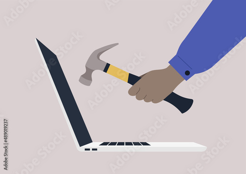 Hand smashing a laptop with a hammer, rage and anger at work