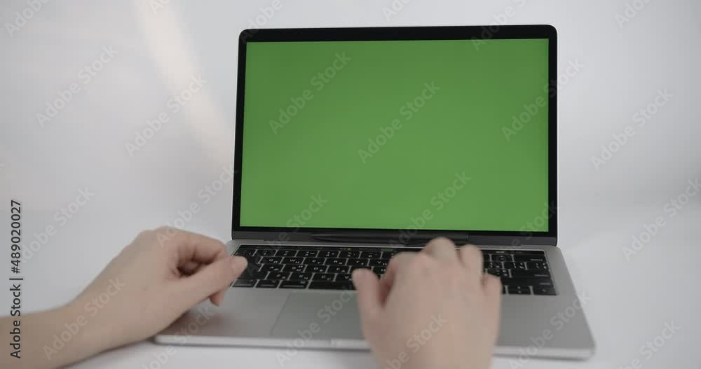 Close Up Green Screen Mock Up on a Laptop Computer. Person Uses Touch Pad Close Up Green Screen Mock Up on a Laptop Computer. Person Uses Touch Pad