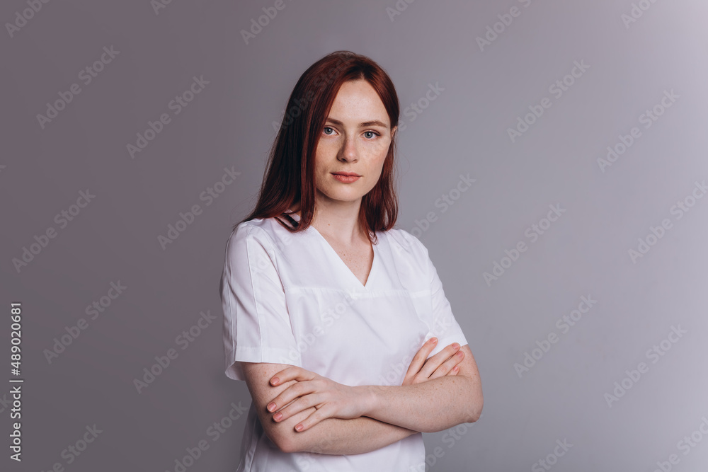 Fototapeta premium Medicine personal in uniform. Young woman doctor in clinic. Health care concept