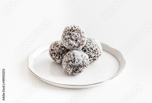 Coconut balls on a white Herend porcelain plate.