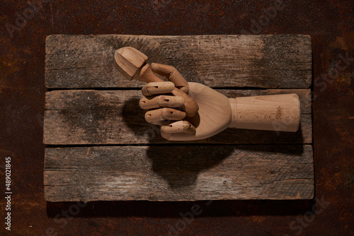 Wooden hand with reamer on cutting board photo