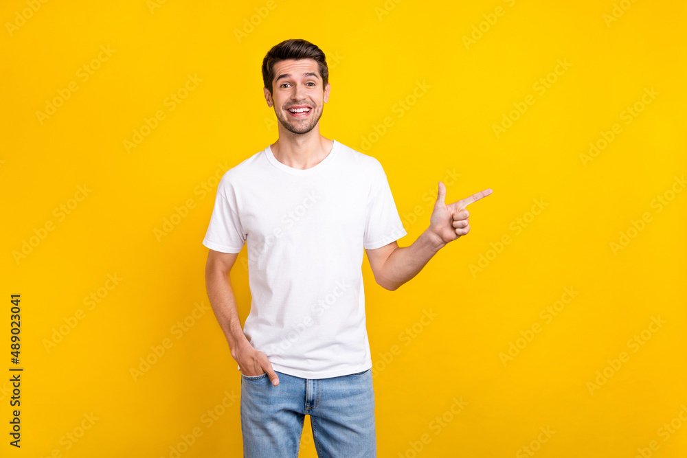 Photo of funny millennial brunet guy index promotion wear casual cloth isolated on yellow color background Photo of funny millennial brunet guy index promotion wear casual cloth isolated on yellow color background