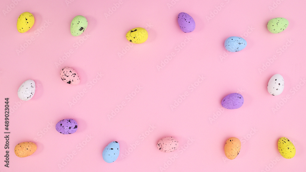 Copy space pastel pink background pattern with colorful eggs on pastel pink theme. Bright trendy flat lay composition. Copy space pastel pink background pattern with colorful eggs on pastel pink theme. Bright trendy flat lay composition.