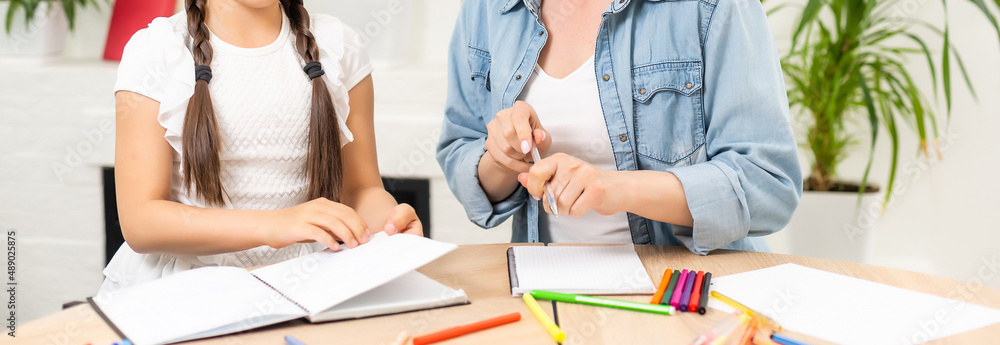 Mother and daughter spending time together at home drawing Mother and daughter spending time together at home drawing